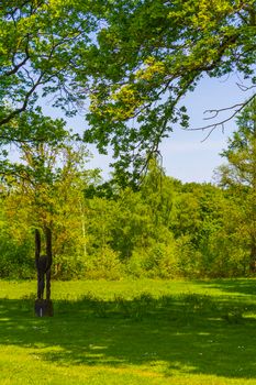 Natural beautiful panorama view with lake river walking pathway and green plants trees in the forest of Speckenbütteler Park in Lehe Bremerhaven Germany.