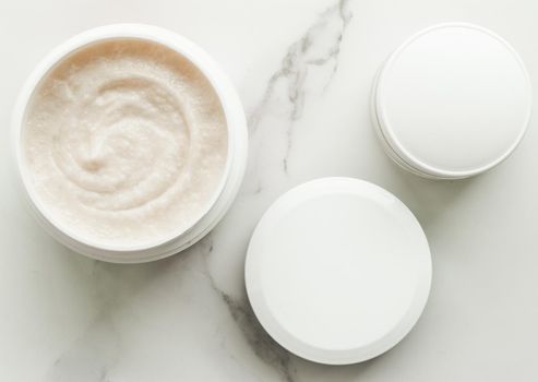 Scrub and exfoliating cream products on a marble, flatlay - skincare and body care, luxury spa and clean cosmetic concept. Health and beauty of your skin