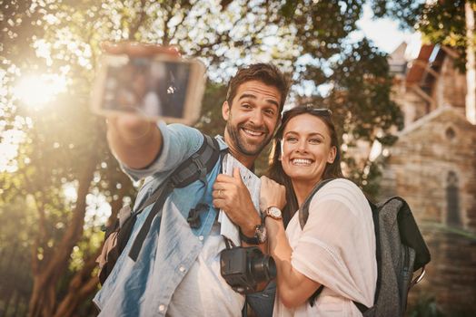 The shared experience of travel brings people together. a happy couple taking a selfie while out in a foreign country