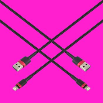 Cable with USB and Lightning connector, isolated on a red background