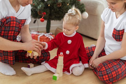 Toddler child with cochlear implant decorating christmas tree deafness and innovating medical technologies for hearing aid