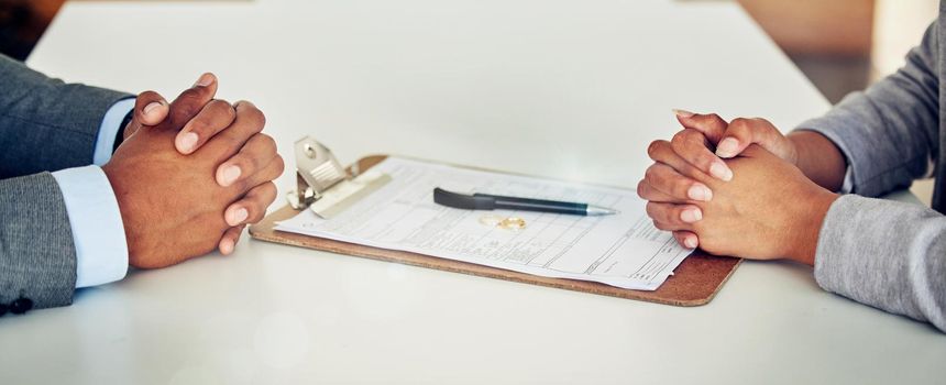 Couple hand sign legal divorce documents, contract or paper deal in a lawyer office with ring placed on table. Woman and man with signature on marriage paperwork after agreement at family law office.
