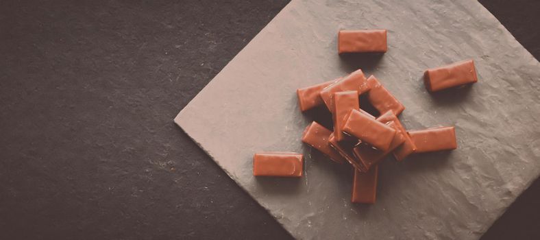 Sweet swiss chocolate candies on a stone tabletop, flatlay - desserts, confectionery and gluten-free organic food concept. All you need is chocolate