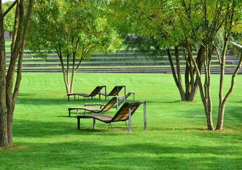 A row of chaise-longue for relaxing in the park