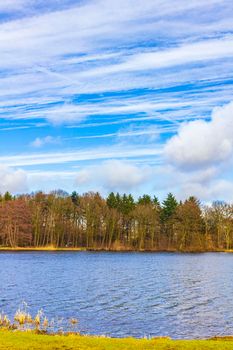 Natural beautiful panorama view with lake river walking pathway and green plants trees in the forest of Speckenbütteler Park in Lehe Bremerhaven Germany.