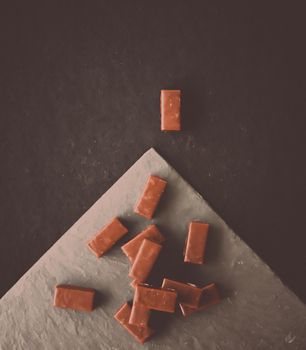 Sweet swiss chocolate candies on a stone tabletop, flatlay - desserts, confectionery and gluten-free organic food concept. All you need is chocolate