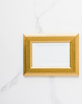 Golden photo frame on marble, flatlay - modern feminine, artwork mock up, luxury design concept. Decorate with chic and style