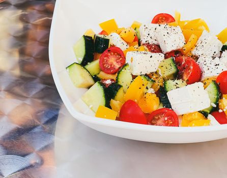 Fresh vegetable greek salad with cherry tomatoes, bell pepper, cucumber, feta cheese, olive oil and seasonal spices, healthy food diet and delicious meal recipe concept