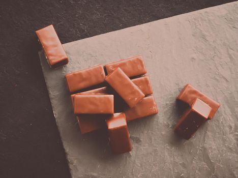 Sweet swiss chocolate candies on a stone tabletop, flatlay - desserts, confectionery and gluten-free organic food concept. All you need is chocolate