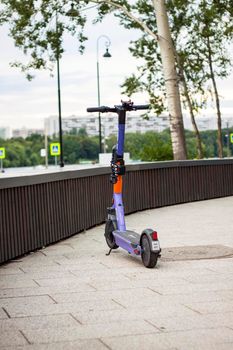 2022-07-17. Russia. Moscow. Northern River Station. A parked city electric scooter. Rent a scooter for a while for your rides. Moscow River