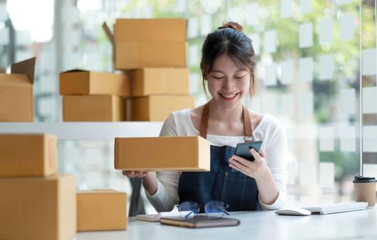 Startup small business entrepreneur SME, asian woman receive order on phone. Portrait young Asian small business owner home office, online sell marketing delivery, SME e-commerce telemarketing concept.