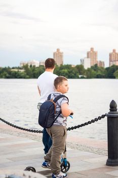 2022-07-17. Russia. Moscow. Northern River Station. Promenade. Walking along the embankment on scooters on a summer day.