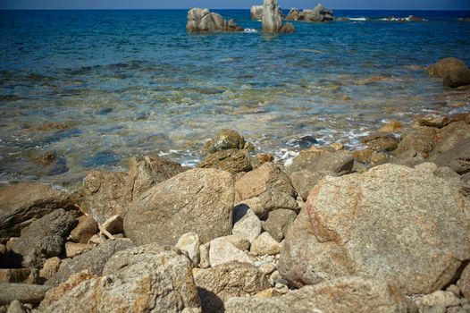 Rocks and rocks of southern Sardinia blend with the crystalline sea.