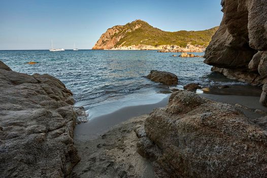 Wiew frof low perspective of Exit to a natural cave on the beach of Cala Sa Figu in the south of Sardinia near Cagliari during the summer.