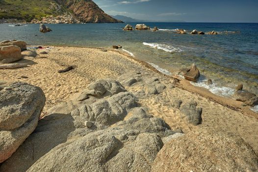 Beautiful Mediterranean beach typical of the coast of southern Sardinia taken over in summer.