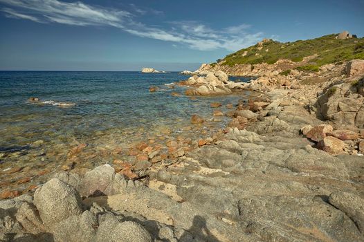Rocky panorama of Cala Sa Figu beach in Sardinia: rocks and rocks meet the blue and crystalline sea.