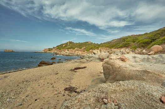 Seascape of a typical southern Mediterranean sardinia beach with sea and rocky headlands typical of the territory.