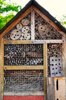 insect hotel. wooden insect house hanging from tree. Insect house - hotel in a summer garden. peculiar wooden houses for insects.