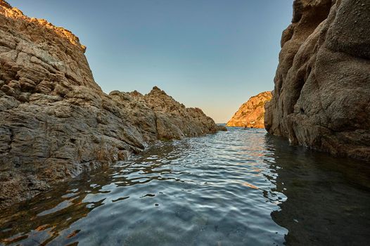 View from the water of a pair of sea cliffs typical of the south coast of Sardinia.