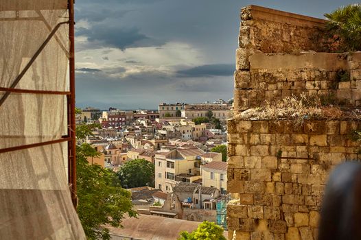 Glimpse filtered by a decaying wall of the city of Cagliari