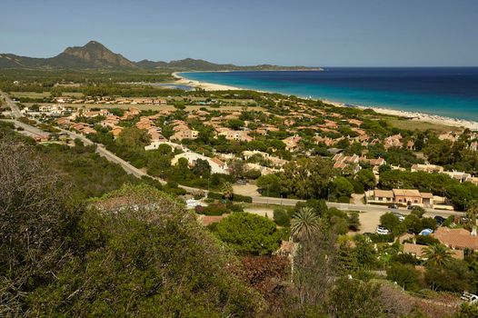 Aerial view of the village of Costa Rei in the south of Sardinia: a small tourist town built on the seashore, in a paradisiacal area.