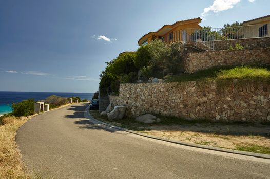 A glimpse of the upper part of Costa Rei village in the south of Sardinia with its characteristic houses and the small streets overlooking the sea.