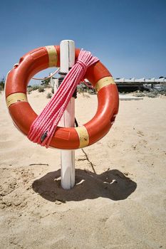 Lifebuoy hanging on the beach ready to use in case of need: safety device.