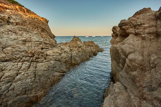 Cliff on the sea at sunset: typical view of the south coast of Sardinia.