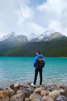 Lake Louise Banff national park is a lake in the Canadian Rocky Mountains. Young men visiting Lake Louise during a vacation in Canada