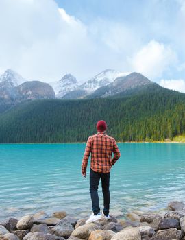 Lake Louise Banff national park is a lake in the Canadian Rocky Mountains. Young men visiting Lake Louise during a vacation in Canada