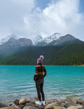 Lake Louise Banff national park, is a lake in the Canadian Rocky Mountains. Young Asian women visiting Lake Louise in Canada during vacation