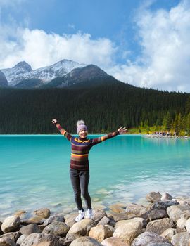 Lake Louise Banff national park, is a lake in the Canadian Rocky Mountains. Young Asian women visiting Lake Louise in Canada during vacation