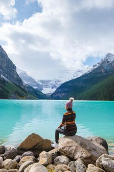 Lake Louise Banff national park, is a lake in the Canadian Rocky Mountains. Young Asian women visiting Lake Louise in Canada during vacation