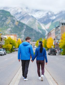 Banff village in Banff national park Canada Canadian Rockies during Autumn fall season. Couple of men and women on vacation in Banff Canada between the mountains