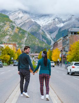 Banff village in Banff national park Canada Canadian Rockies during Autumn fall season. Couple of men and women on vacation in Banff Canada between the mountains