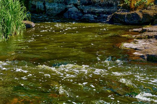 a large natural stream of water flowing in a channel to the sea, a lake, or another such stream.