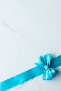 Holiday decor, feminine design and flatlay concept - Blue silk ribbon on marble, top view