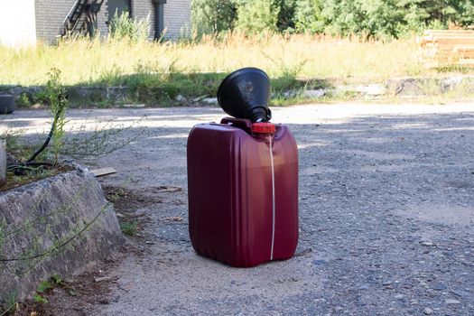 Large red canister of engine oil close up