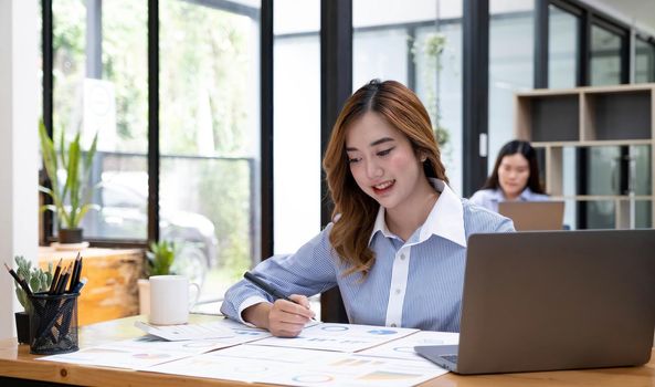 Portrait of smiling beautiful business asian woman working in office use computer with copy space. Business owner people sme freelance online marketing e-commerce telemarketing, work from home concept.