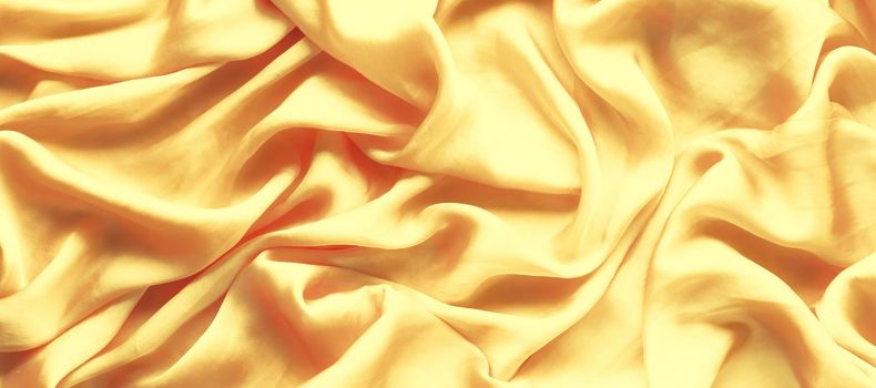 Luxury golden silk background texture - elegant fabric textures, abstract backgrounds and modern pastel colours concept