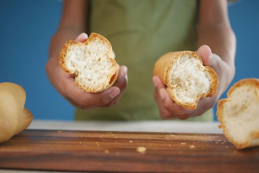 cutting long bread on a chopping board ,