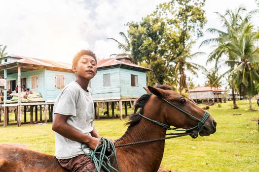 Afro-descendant boy riding a horse in a Caribbean community in Nicaragua