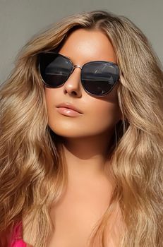 Luxury fashion, travel and beauty face portrait of young blonde woman, wearing chic sunglasses, suntanned skin and long beach waves hairstyle, summer accessory and glamour style concept