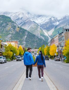Banff village in Banff national park Canada Canadian Rockies during Autumn fall season. Couple of men and women on vacation in Banff Canada between the mountains