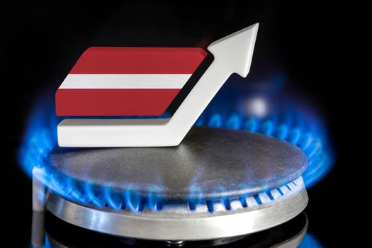 Gas price. Rise in gas prices in Latvia. A burner with a flame and an arrow up, painted in the colors of the Latvia flag. The concept of rising gas or energy prices