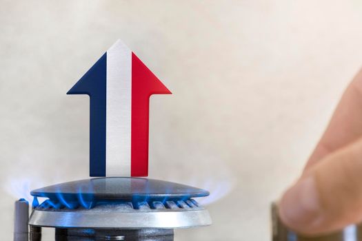 Gas price. Rise in gas prices in France. A burner with a flame and an arrow up, painted in the colors of the France flag. The concept of rising gas or energy prices