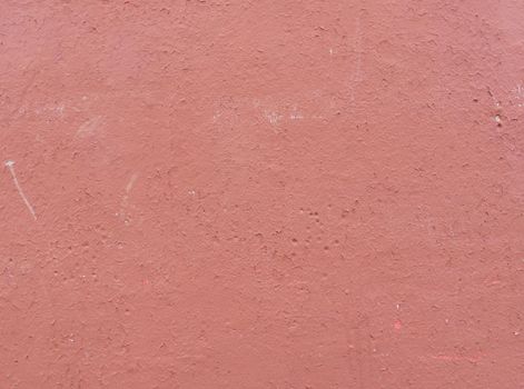 Old peeling red paint on an old wall. Abstract background for design. red cement wall texture