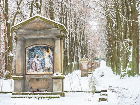 Calvary, Saint paints stations of the Cross in park near Cvikov, Czechia. Winter season with snow cover