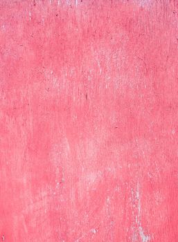 Plywood surface with worn, time-damaged red paint. Fuchsia color decorative background. Coral texture.