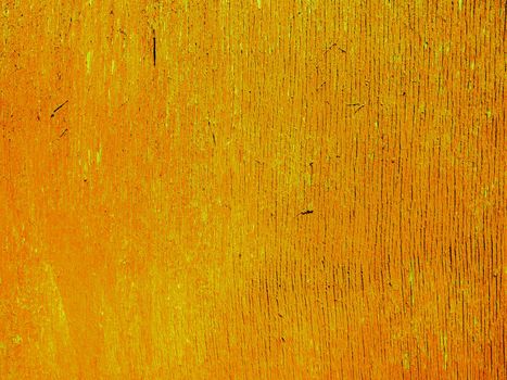 Abstract yellow bright wood texture. The surface of a wooden orange wall damaged and aged by time and weather.